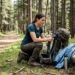 Hiker preparing backpack in national park